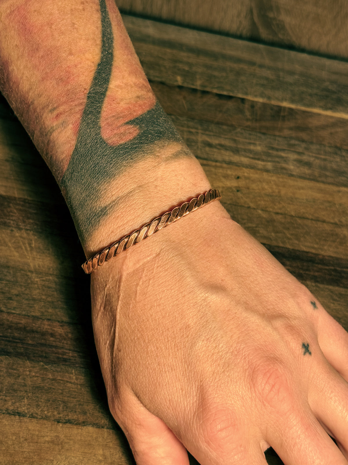 Hand forged Infinity Twist copper cuff with twisted form.