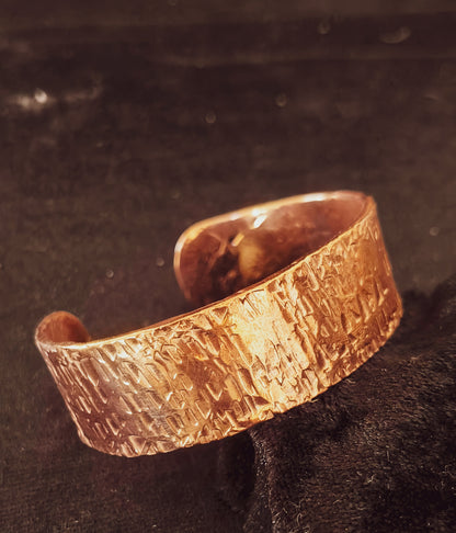 Hand forged copper cuff with textured hammered finish.